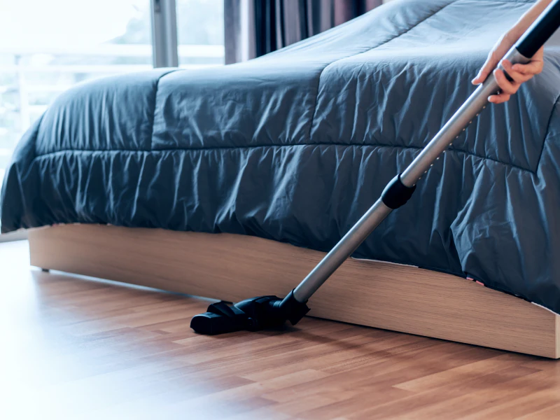 a cleaning contractor using a vacuum to clean a houses bedroom sewell nj